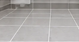 Restored grout lines on grey floor tiles